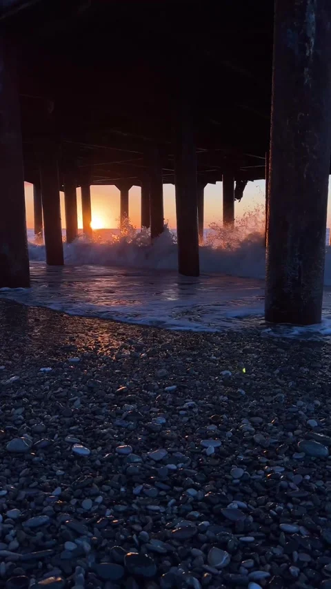 Vertical 4K video. Ocean waves crash against wooden pillars, bridge and pier Stock Footage 271168774