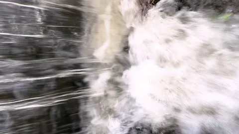 Vertical 4k video of rapid bubbling flow of water of a mountain river close-up 스톡 동영상 218581269