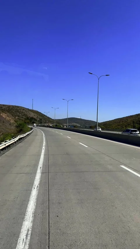 Vertical 4K video. View from car window of mountain, highway, lantern, markings Video stock 291923680