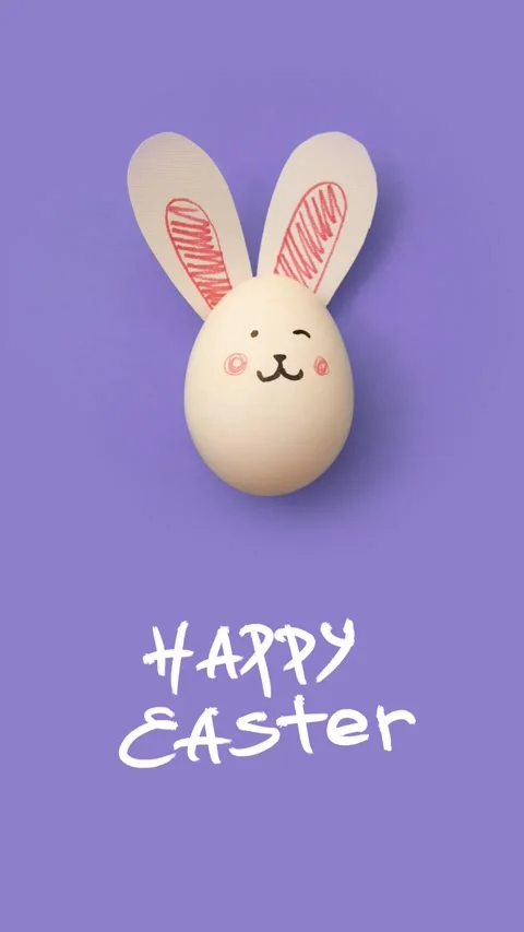 Vertical 4K video. White chicken egg with cute bunny face and rabbit ears Stock Footage 276569422