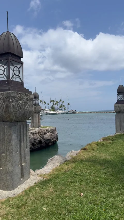 Vertical 4K View Through Historic Waterfront Columns As Boat Turns In Aruba Stock Footage 335344731