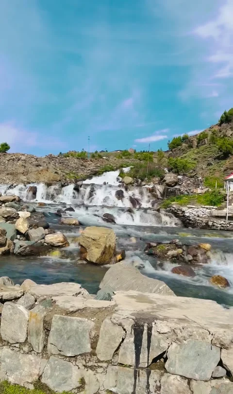 Vertical 4K Waterfall Cascading in Lush Green Mountain Wilderness, 60fps Stock Footage 329391992