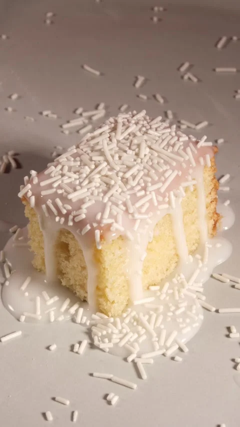 Vertical 4K White Chocolate Vermicelli Falling on Cake Stock Footage 333320688