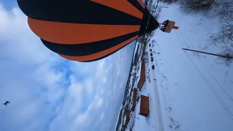 Vertical 5k FPV Drone Shot of Hot Air Balloon Above Snow Capped Land Stock Footage 195454555