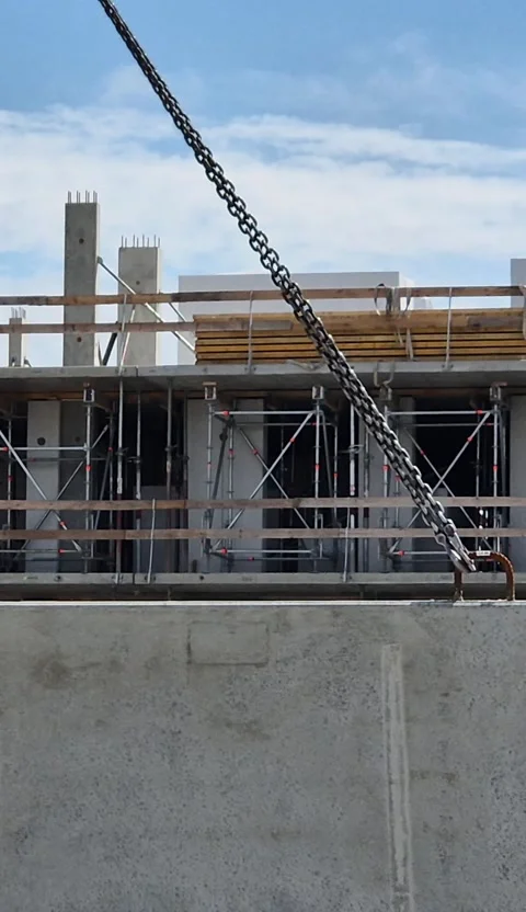 Vertical 9 16 Tower Crane Lifting Concrete Wall Stock Footage 338400576