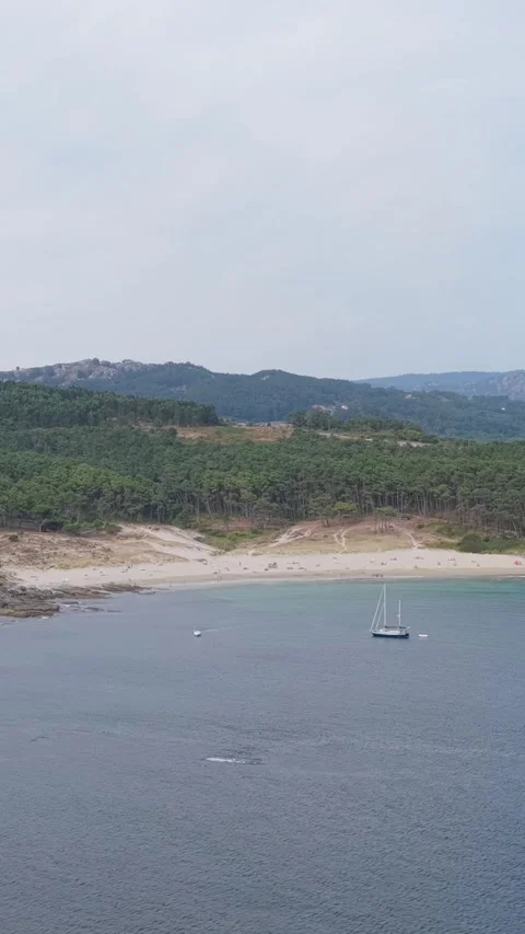 Vertical 9:16 aerial video framing of Praia de Melide in Cangas, Spain, showing Stock Footage 346662925