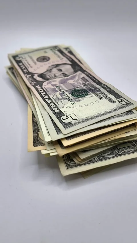 Vertical 9:16 stop-motion timelapse showing a stack of US dollar banknotes Stock Footage 341325922