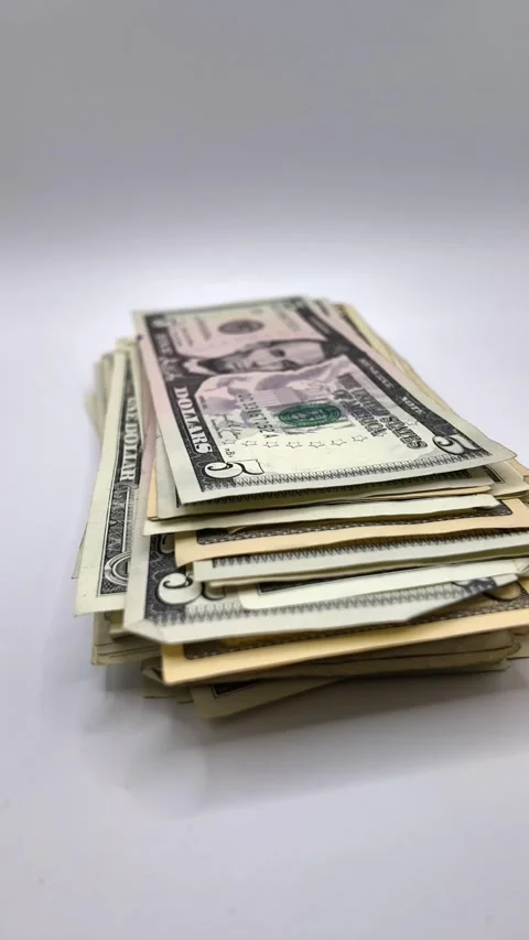 Vertical 9:16 stop-motion timelapse showing a stack of US dollar banknotes Stock Footage 341325962