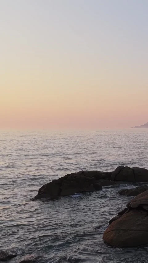 Vertical 9:16 video captures the tranquil beauty of the Baiona coastline in Stock Footage 346663027