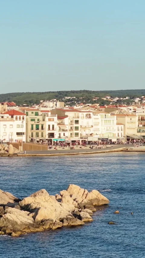 Vertical 9:16 video framing of the LEscala waterfront in Spain, showing rocky Stock Footage 346662764