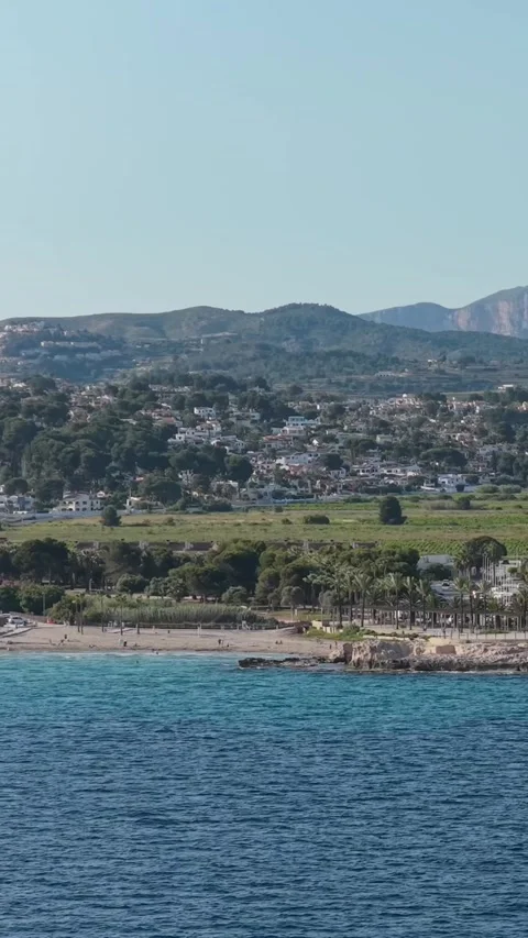 Vertical 9:16 video framing of Moraira, Spain, showing a vibrant Mediterranean Stock Footage 346662546