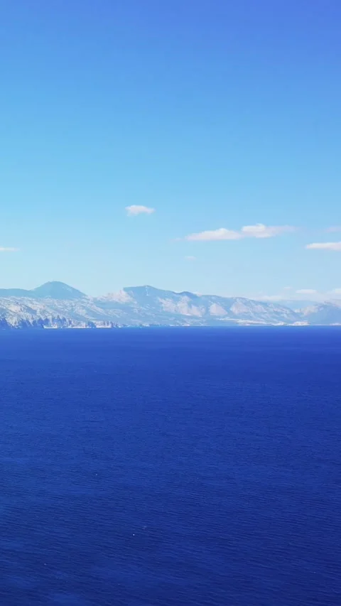 Vertical 9:16 video showing the dramatic cliffs and clear blue sea near Cala Stock Footage 346663020