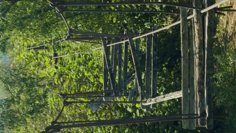 Vertical abandoned suspension bridge Stock Footage 246958835