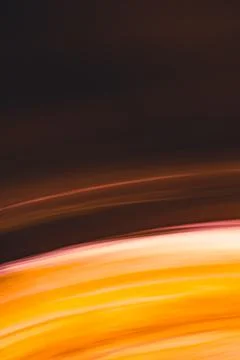 Vertical abstract background in warm colors. Yellow orange arc lines in shade Stock Photos