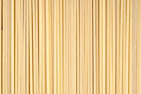 Vertical abstract texture pattern of straight dry Italian spaghetti pasta Stock Photos