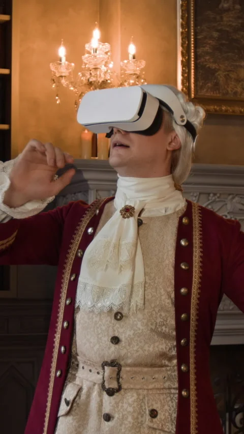 Vertical of Actor in Historical Costume and AR Headset Browsing Storyboard Stock Footage 316718681
