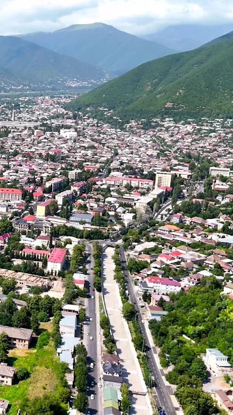 Vertical aerial 4K view of Sheki city surrounded by Caucasus mountains Видео 341337275