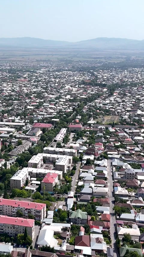 Vertical aerial 4K view of Sheki city surrounded by Caucasus mountains Stock Footage 341337323