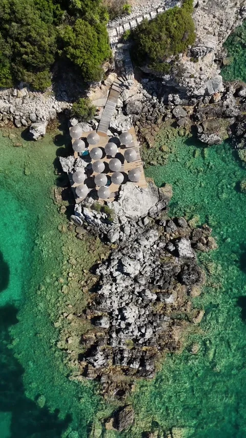 Vertical aerial 4K view of underwater rock formations in transparent turquoise o Stock Footage 340560310