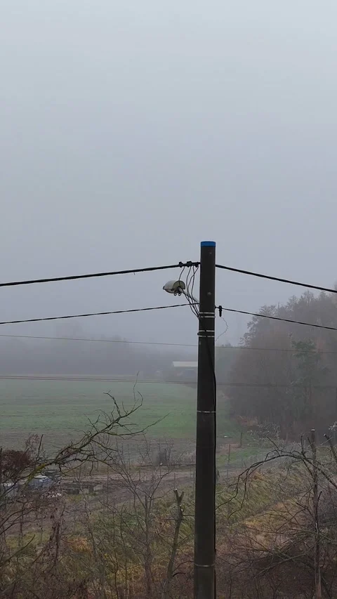 Vertical Aerial Arc Right Flight Around Wooden Power Pole in Fog Stock Footage 323965877