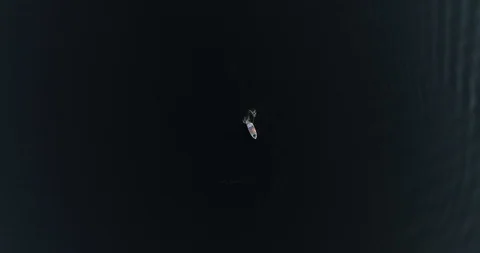 Vertical aerial down top view.  Wakeboard follows the boat. Video stock 94927992