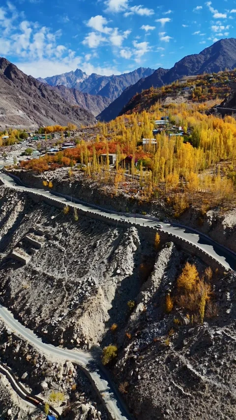 Vertical aerial drone above twisting river, scenic roads and yellow woods. Stock Footage 310665062