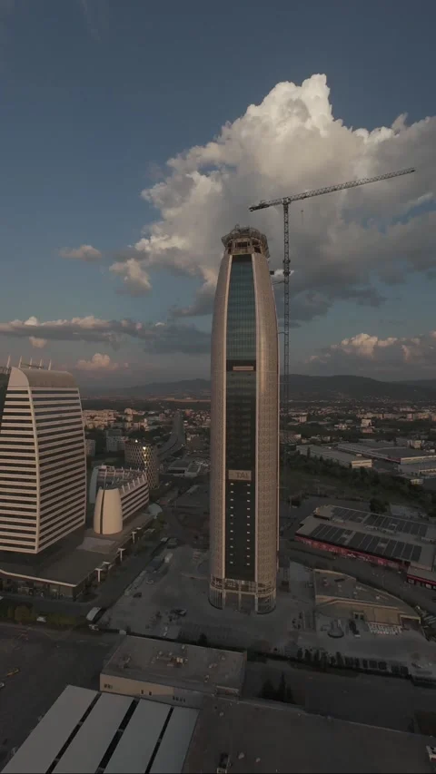 Vertical aerial drone pullback revealing modern skyscraper in Sofia, Bulgaria. Video stock 340814529