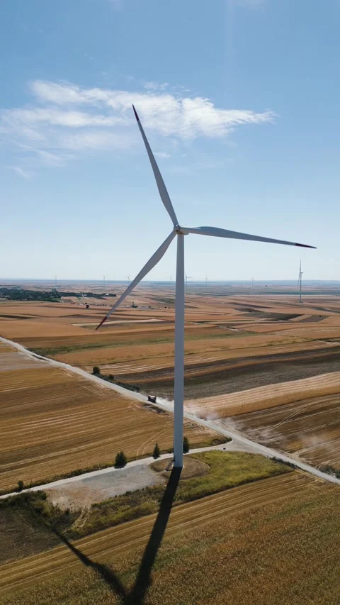 Vertical aerial drone shot flying to the left around a wind turbine in a ru.. Stock Footage 344601714