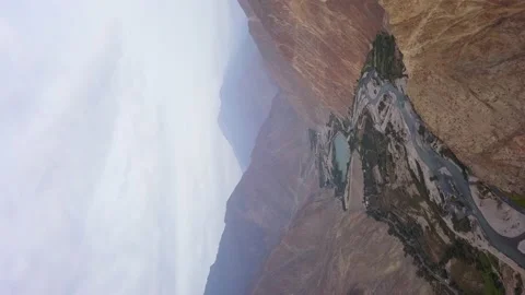 Vertical aerial drone view of a beautiful and fragmented river between green far Stock Footage 199566244