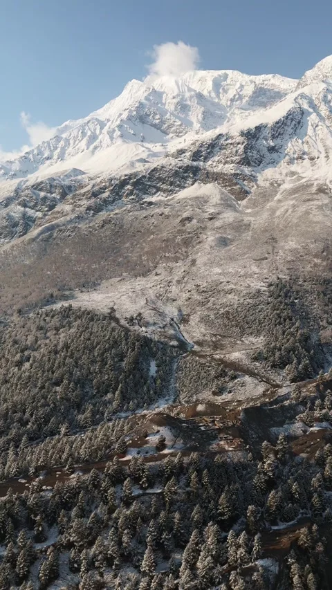 Vertical Aerial drone view capturing the peaceful stillness of Manang’s mountain Stock Footage 311019179
