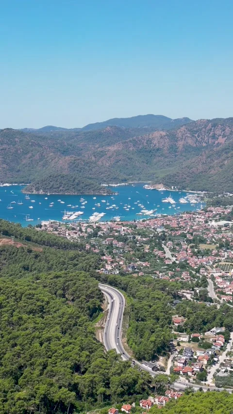 Vertical aerial drone view of Gocek bay, coastal road, and marina in Fethiye Stock Footage 340025003