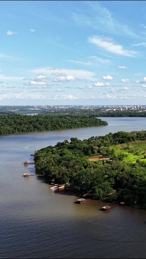 Vertical Aerial Drone View of Large Lake and Distant City Skyline Video stock 346923084