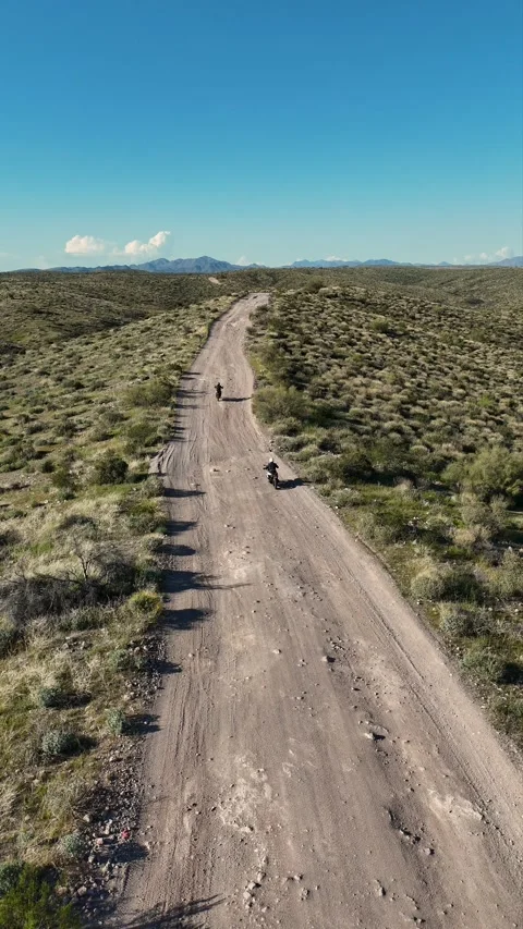 Vertical Aerial Drone View Of People Riding Dirt Bikes On Rugged Road Arizona Stock Footage 343881279