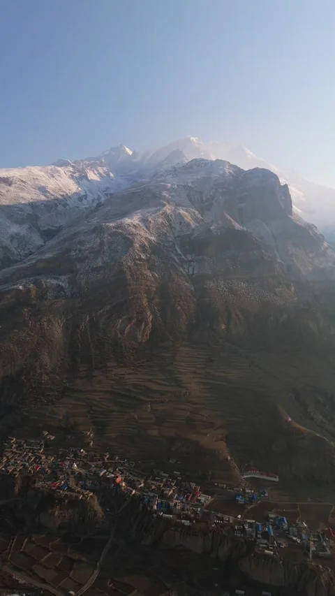 Vertical Aerial drone view showcasing the harmony of village life and the Stock Footage 311019115