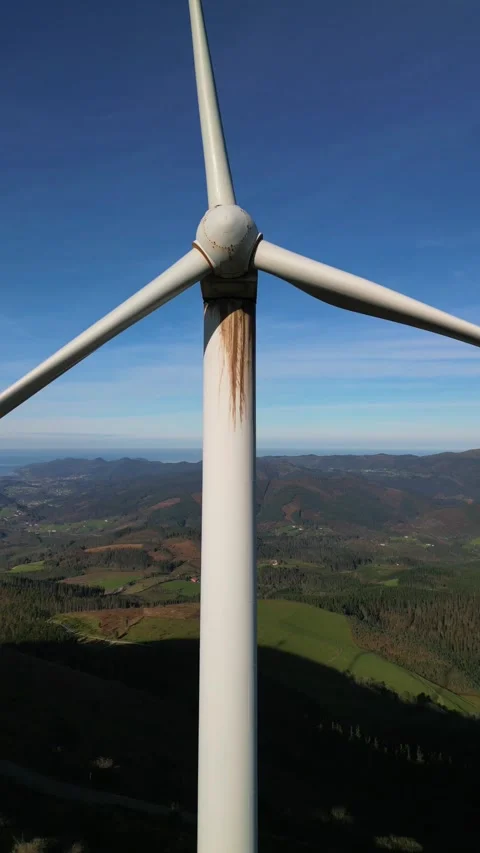 Vertical aerial drone view of wind turbine rotating showing green energy la.. Stock Footage 294976150