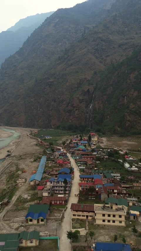 Vertical Aerial drone view of winding pathways leading to a picturesque valley Stock Footage 311019340