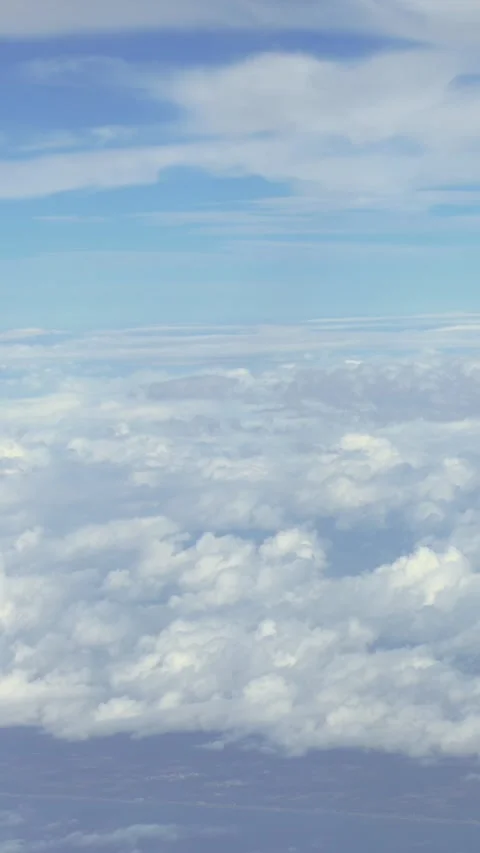 Vertical Aerial expansive of sky, showcasing cumulus clouds and the horizon Stock Footage 299083926