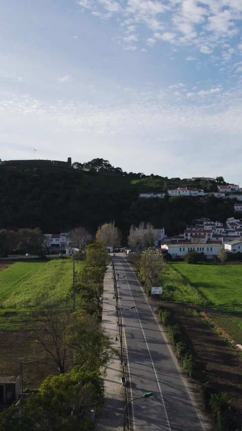 Vertical Aerial Fly-over of Road Leading to Aljezur Village Stockbeeldmateriaal 333626549