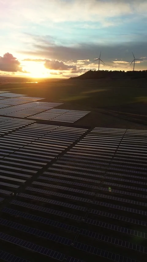 Vertical Aerial Forward Flight Over Solar Panels with Wind Turbines Stock Footage 325127664