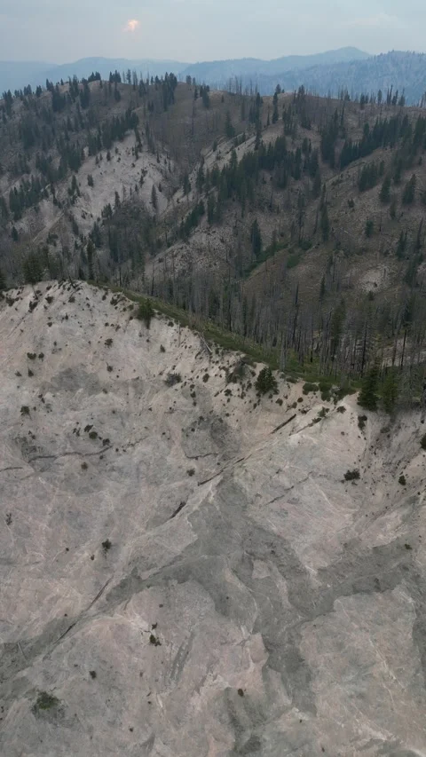 Vertical aerial of grey cliffs and mountains in Boise National Forest in Idaho Stock Footage 256044064