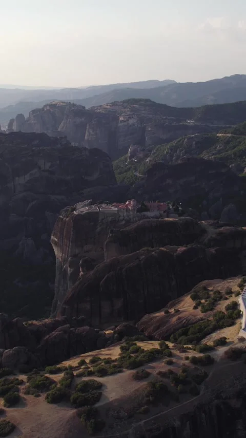 Vertical Aerial of Holy Trinity Monastery Amid Meteora Rock Formations Stock Footage 322153977