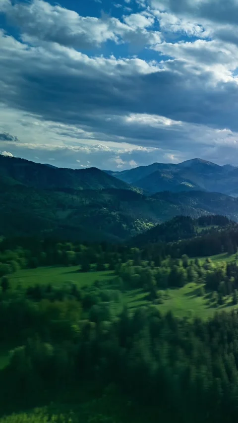 Vertical Aerial hyperlapse hilly Carpathian landscape, the suns rays shine Stock Footage 310723920