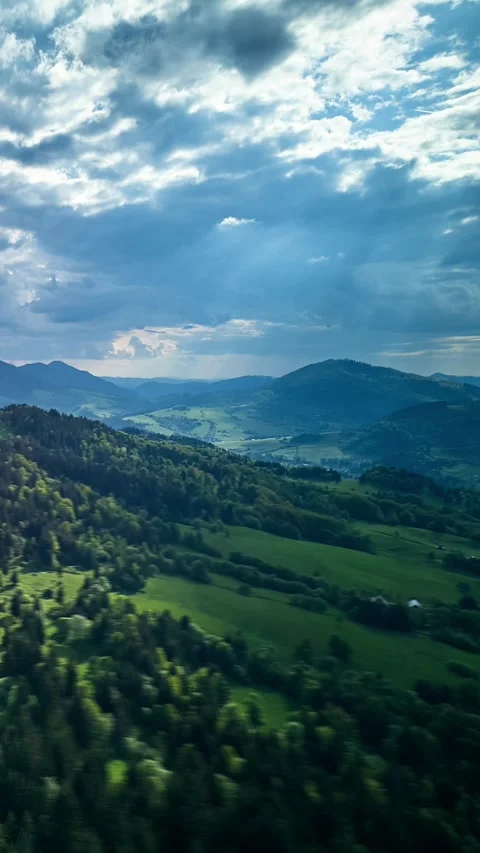 Vertical Aerial hyperlapse hilly Carpathian landscape, the suns rays shine Stock-Footage 310723944