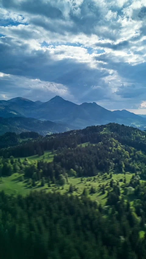 Vertical Aerial hyperlapse hilly Carpathian landscape, the suns rays shine Stock Footage 310723983