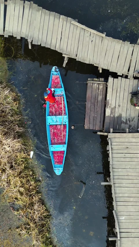 Vertical aerial lens documenting the slicing of snow to move boats in Dal Lake’s Stock Footage 311020035