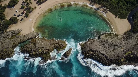 Vertical Aerial Moving Over Secluded Beach Shaped By Unique Rock Formation Stock-Footage 101657003