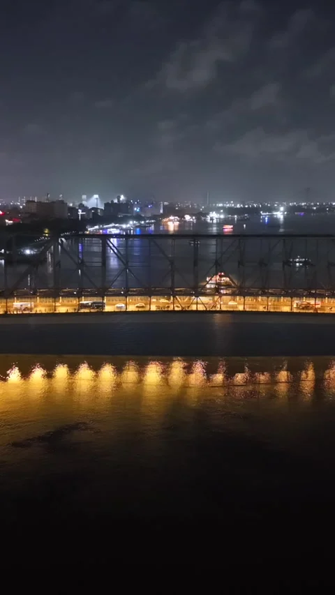Vertical Aerial Night View of Howrah Bridge and Ferry Kolkata India Stock Footage 330719321