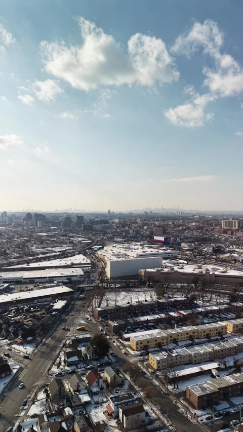 Vertical Aerial Pan From Cloudy Sky to Queens Rail Infrastructure Stock Footage 345615019