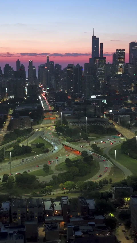 Vertical aerial panning in front traffic on I-90 and the skyline of Chicago Stock Footage 328225334