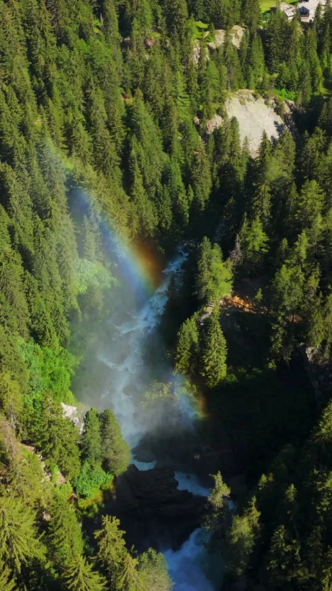 Vertical Aerial Panning of Waterfall with Rainbow and Forest Mist landscape Vídeos de archivo 334093199